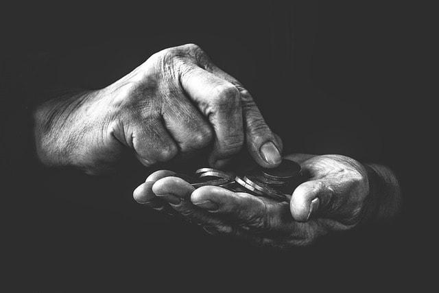 A black and white protrait of a pair of hands counting money.