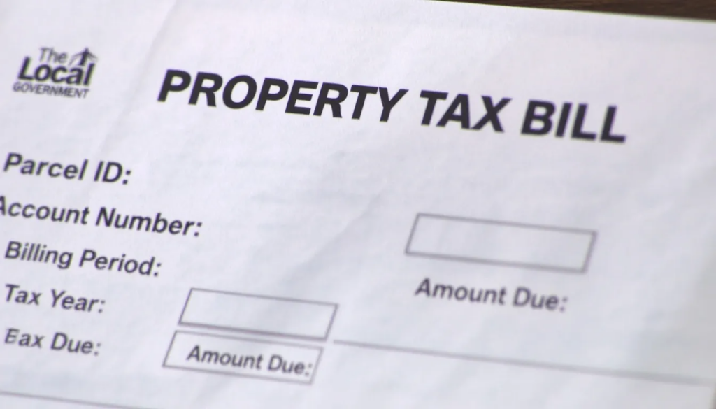 An image depicting the concept of property tax in South Carolina, illustrating various elements such as a calculator, a home, and documents related to property taxes, highlighting the importance of assessment ratios and the homestead exemption for primary residences in Charleston County. The scene emphasizes the process of estimating taxes by multiplying the property's assessed value by the total millage rate.